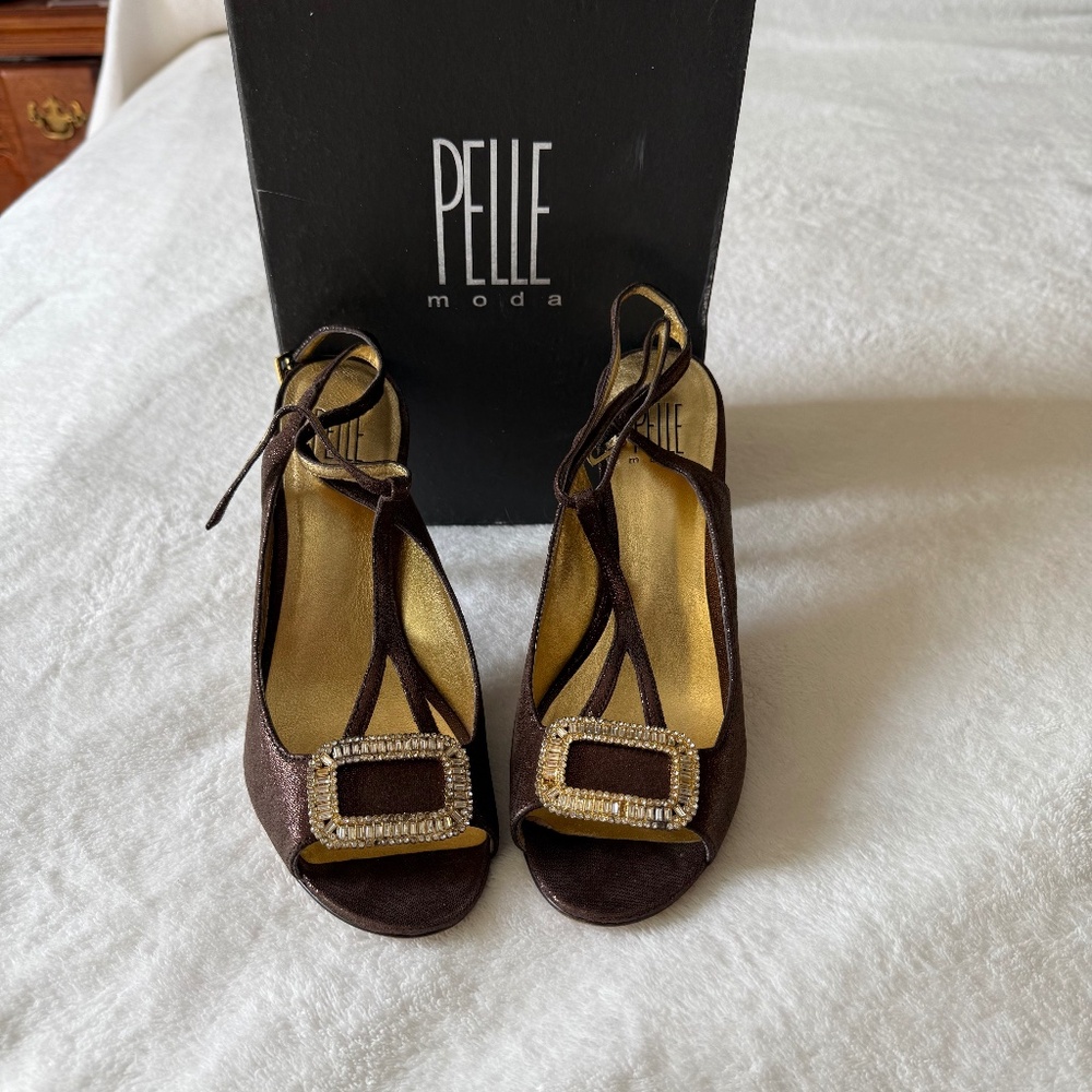 A stunning brown high-heel sandal adorned with a radiant rhinestone buckle!